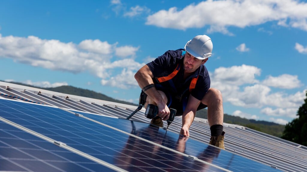 solar panel installer on the roof